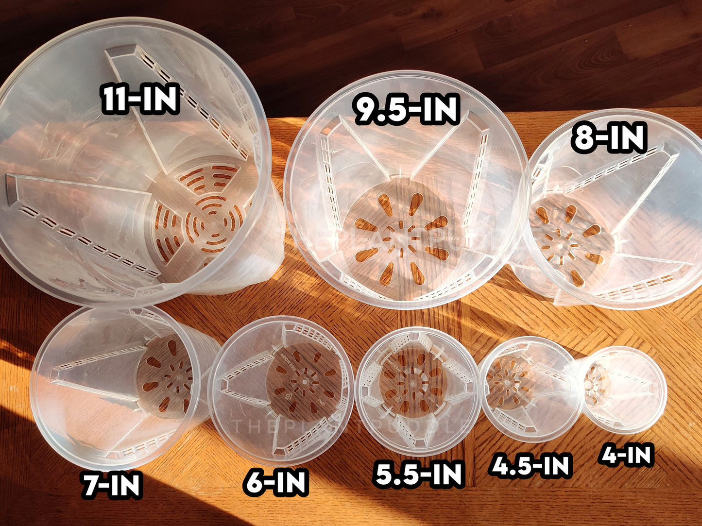overhead view of 8 sizes of tall plant pots showing drainage hole patterns