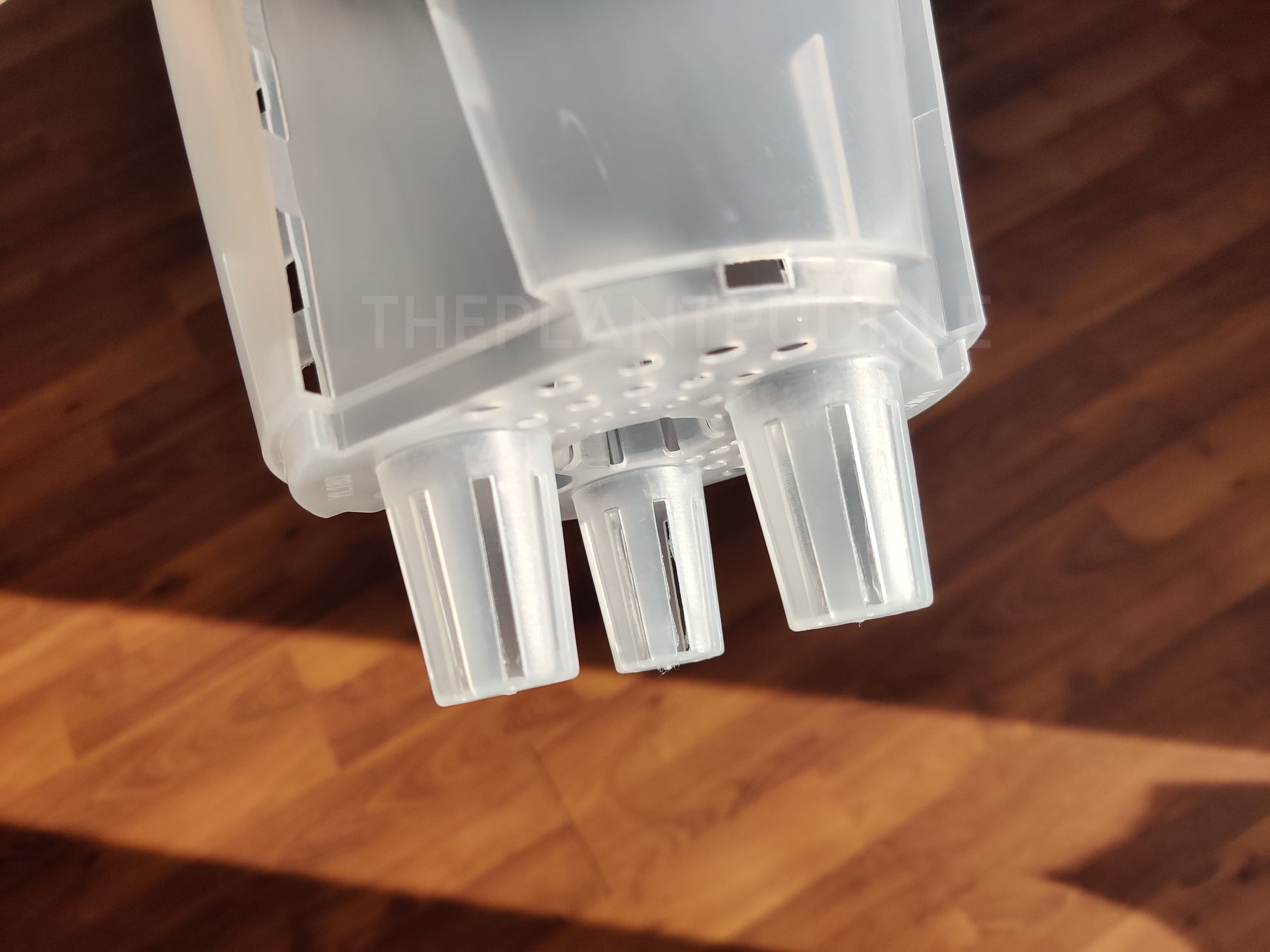 view of netted legs of self watering plant pot