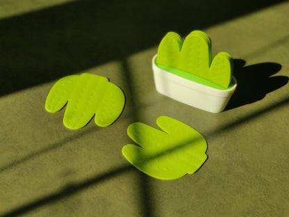 green cactus-shaped coasters on a table