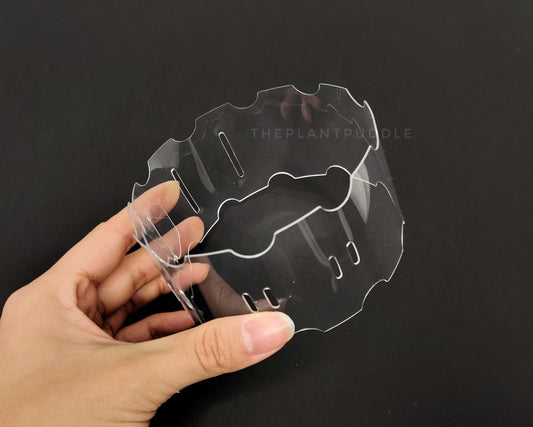 hand holding a clear pot extender