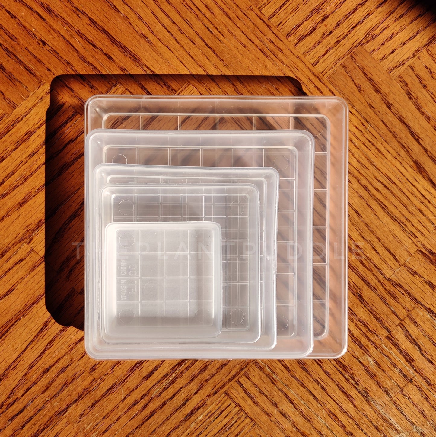 square plant pot saucers stacked