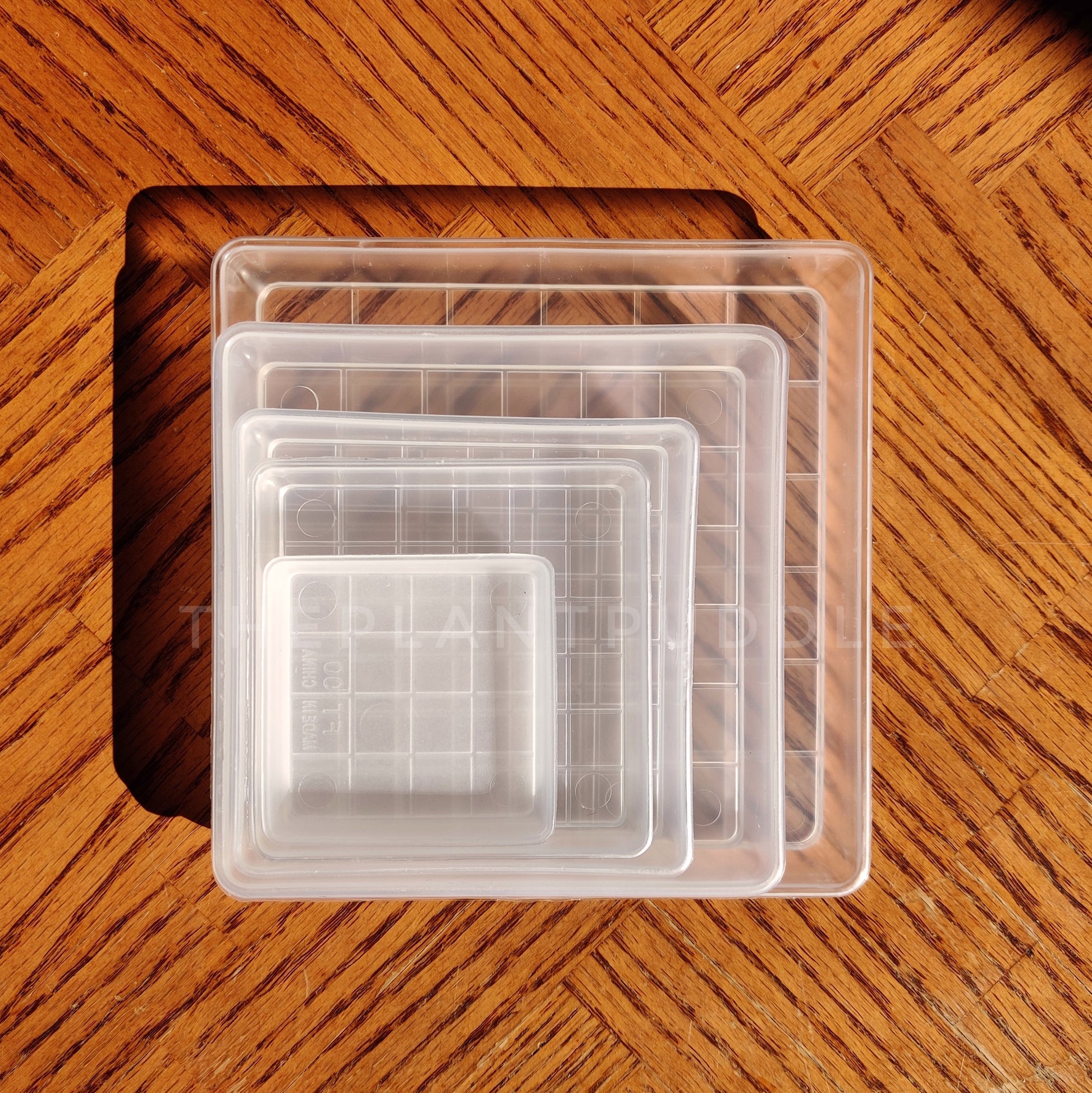 square plant pot saucers stacked