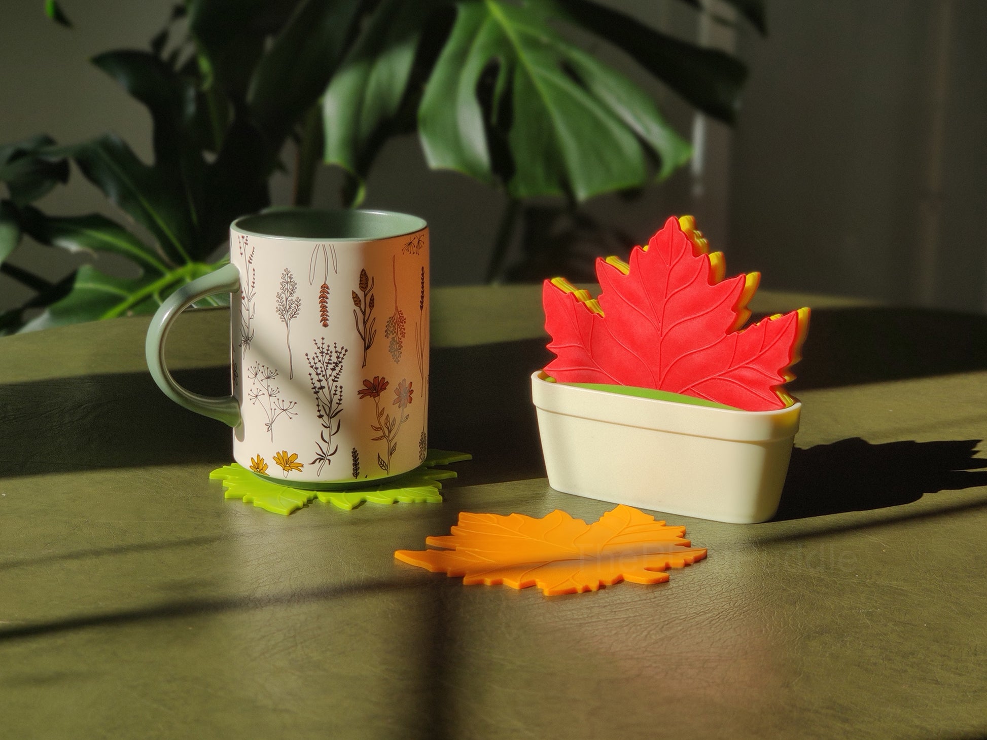 colourful maple leaf shaped coasters with a mug