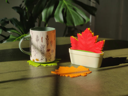 colourful maple leaf shaped coasters with a mug