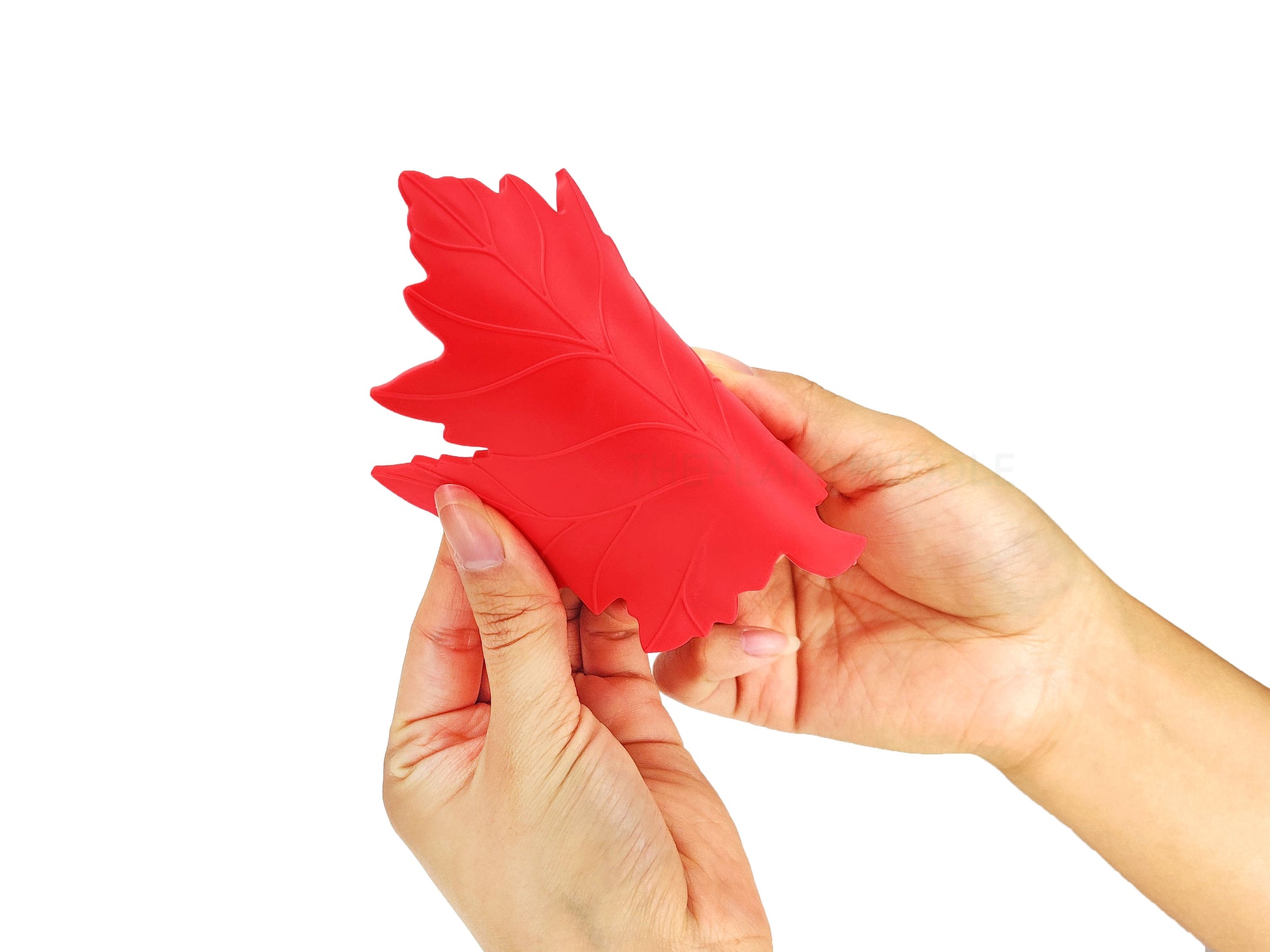 red leaf coaster used to show flexibility in hands